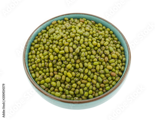 View of raw green mung beans inside a small round turquoise ceramic bowl on white background