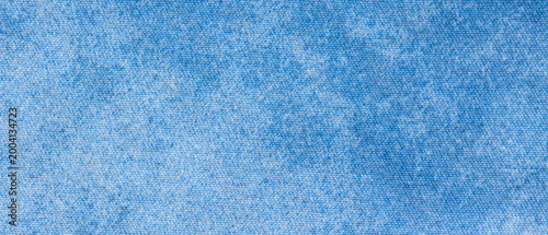 Light blue denim chambray fabric texture with fine woven surface as a background