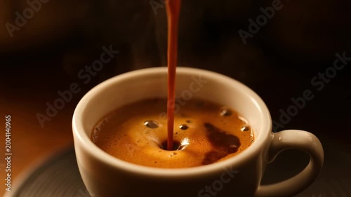 Hot coffee pouring into cup with splash and ripples close up beverage preparation scene