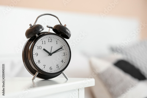 Black alarm clock on table ...