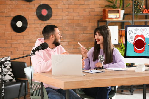 Young couple recording podc...