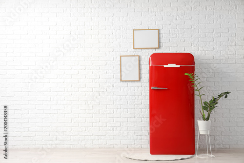 Red retro fridge with plant...