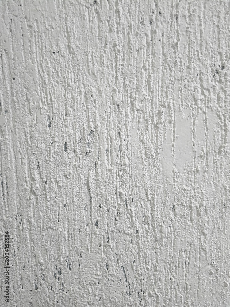 Fototapeta premium Whitewashing a plastered wall for a background