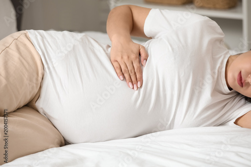 Young pregnant woman suffer...