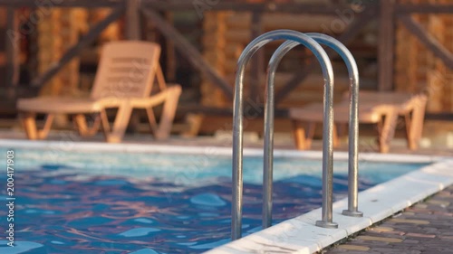Top view of swimming pool with clear water on vacation on sunset background