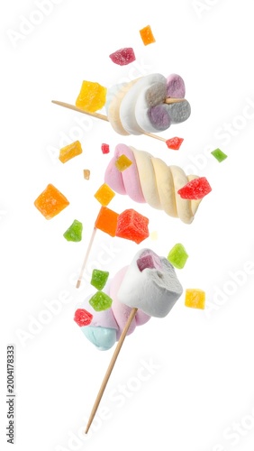 Colorful marshmallows and candy bits in mid-air