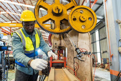 Engineers actively monitor the production line in a metal sheet factory