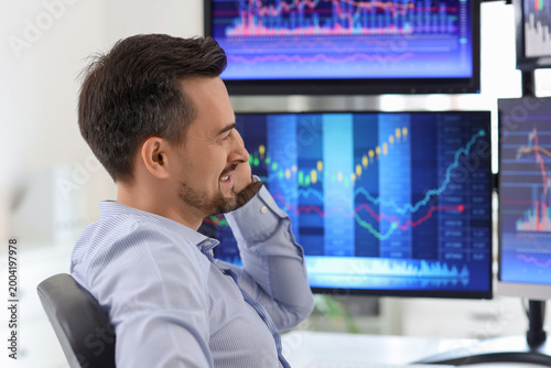 Male trader talking by mobi...