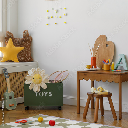 Quadro em tela Children room corner featuring a green toy storage box, plush star pillow, daisy soft toy, and a warm palette — a playful and cozy corner for play and rest
