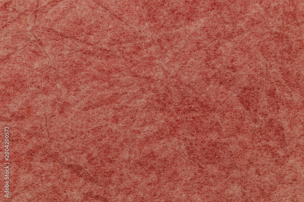 Fototapeta premium Paper with texture shows shades of pink and brown with visible fibers and patterns throughout the surface