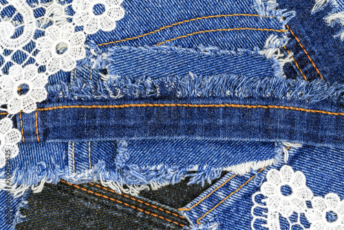 фотографія Denim fabric with lace trims and frayed edges shows various textures and designs