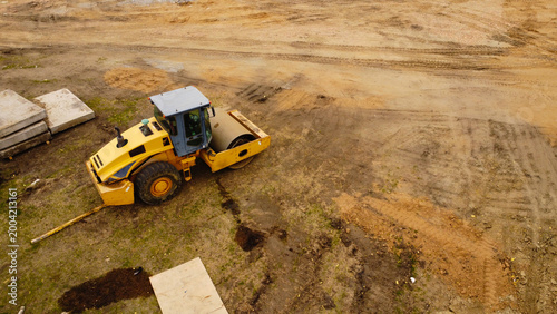 Konstfotografi Aerial View of Yellow Soil Compactor at Construction Site with Building Material