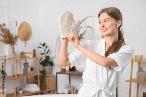 Young woman putting on mass...