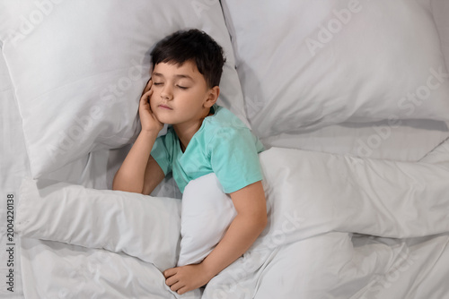 Cute little boy sleeping in...