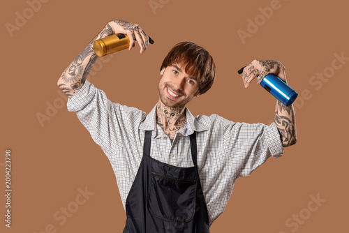 Tattooed barber with hair s...
