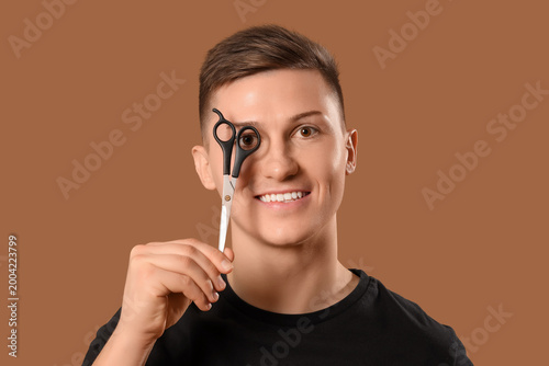 Young barber with scissors ...