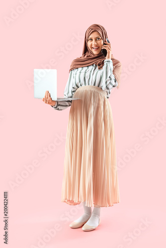 Pregnant Muslim businesswom...