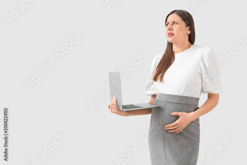 Stressed pregnant businessw...
