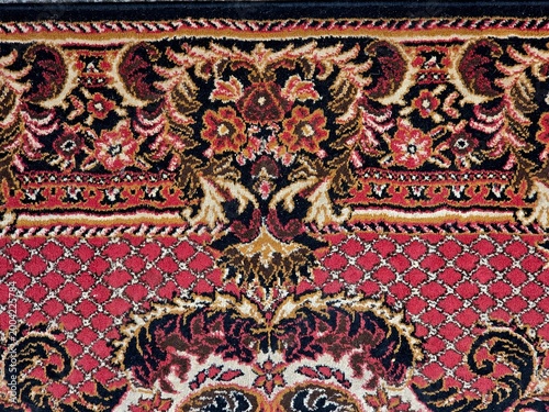 Horizontal oriental rug border with floral ornament, red vintage carpet panoramic texture