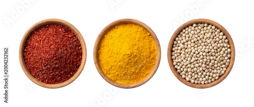 Three Spices in Wooden Bowls Isolated on Transparent Background, Chili Flakes Turmeric Powder and White Peppercorns Top View