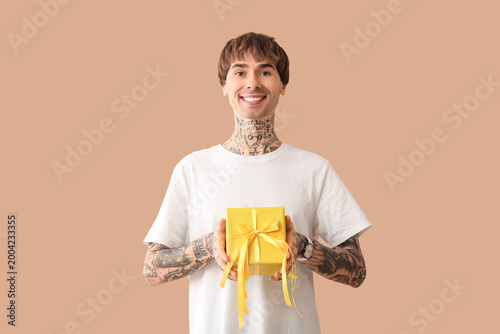 Young tattooed man with gif...