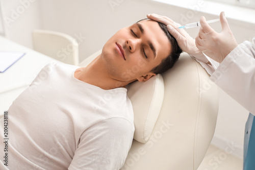Young man receiving injecti...