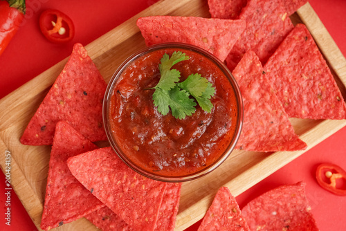 Wooden tray with red nachos...