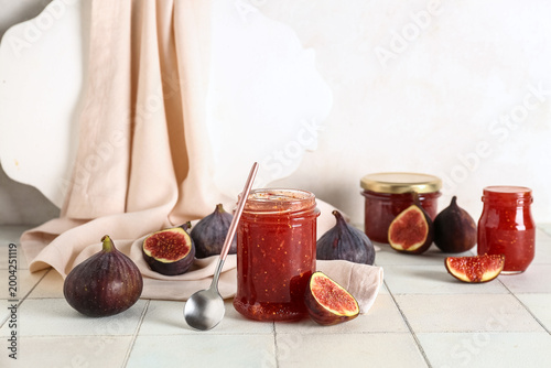 Jars of sweet fig jam on wh...