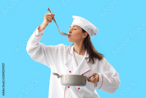 Female chef with ladle and ...