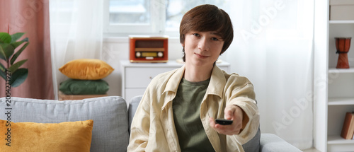 Teenage boy watching TV at ...