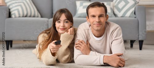 Young couple watching TV on...