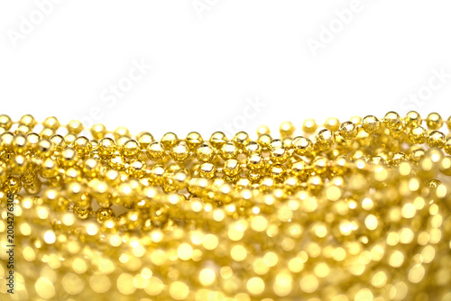 Принти на полотні Golden beads spread out on a white background showing their shape and texture cl