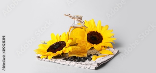Bottle of oil, sunflowers a...