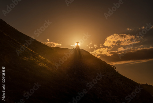 Bild auf Leinwand Dramatic Sunset Landscape with Torre del Gerro Ancient Watchtower Silhouette