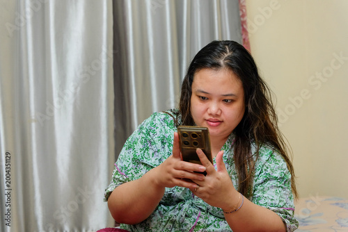 Fotografía Young woman engrossed in her smartphone, browsing content or connecting online f