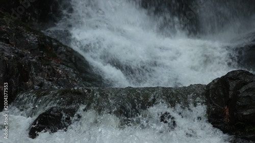 Close up of flowing waterfall stream, clear fresh natural water and peaceful wild nature landscape
