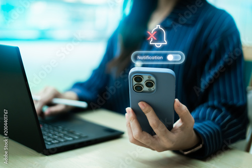 Fotografie User turning off notifications on smartphone with toggle interface