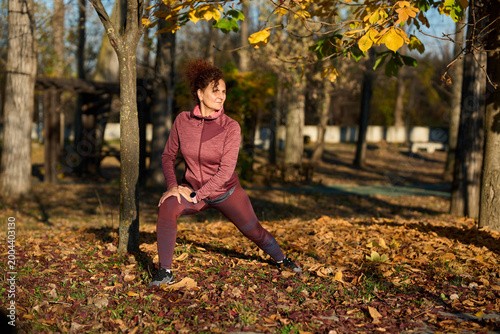 Schilderij op canvas Woman doing lunges in autumn park