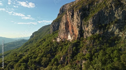 Ostrog Monastery In the cliff  Montenegro at sunset, drone establishing shot. Famous destination of Balkans. 