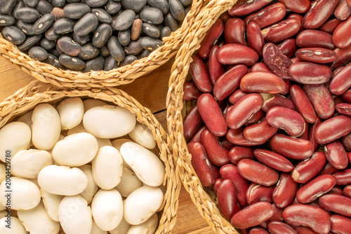 Dried beans, on a wooden table. Top view.