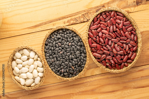 Dried beans, on a wooden table. Top view.