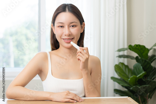 Free Download Lip care protection concept, pretty asian young woman, girl hand applying lipstick balm with moisturizer on dry mouth from natural beauty product, skincare routine, makeup and cosmetics concept. - GFXLoad