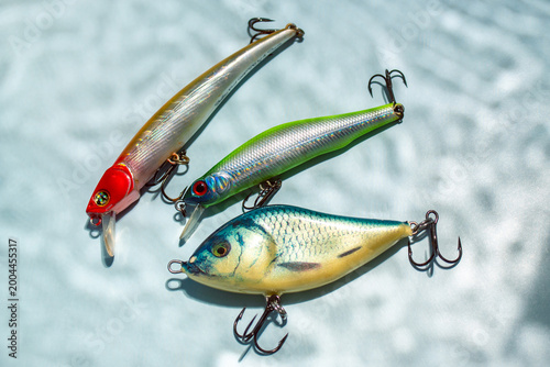 Foto Flat lay of fishing equipment on blue background with water shadows