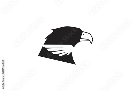 Eagle head silhouette against black background vector design