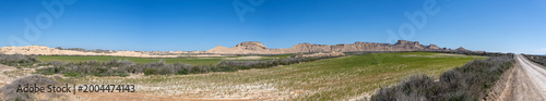 Fotografie Bardenas reales landscape in navarra, spain with badlands and green fields