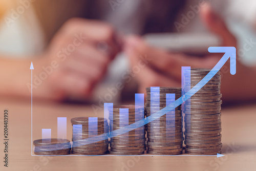 Φωτογραφία Rising coin stacks with upward blue financial graph, representing income growth,