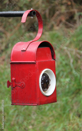 A Red Vintage Oil Fired Portable Warning Signal Light.