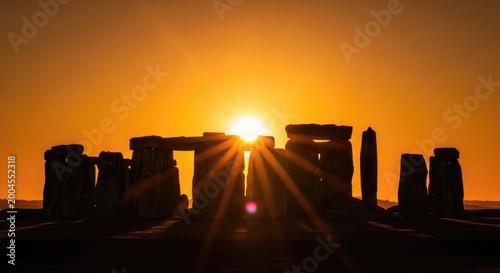 Stonehenge silhouette at sunrise ancient monument bathed in golden light