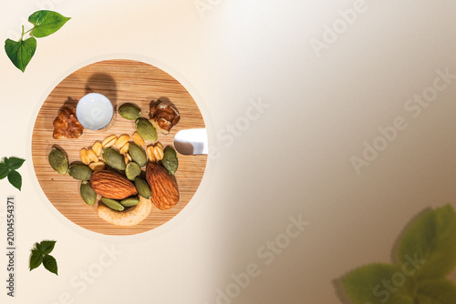 Minimal healthy snack background with assorted nuts and seeds on a wooden board, placed on a soft beige to brown gradient background.