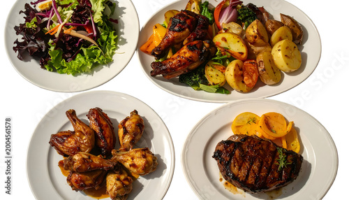 A selection of cooked meals on white plates, including meat, vegetables, and salad